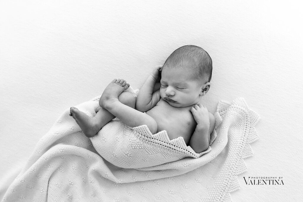 newborn safely posed on his back. Taken during a newborn shoot in London