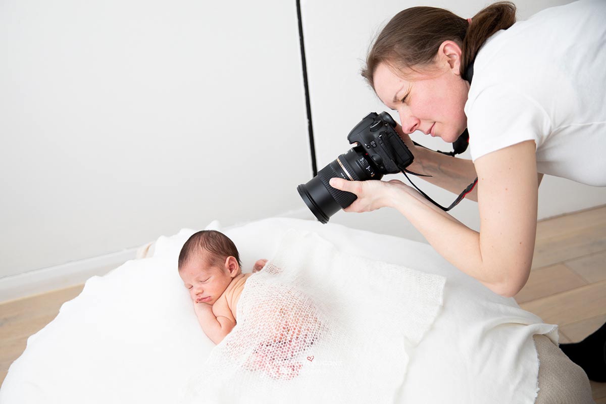 behind the scene showing Valentina, a London newborn photographer, photographing a little newborn baby