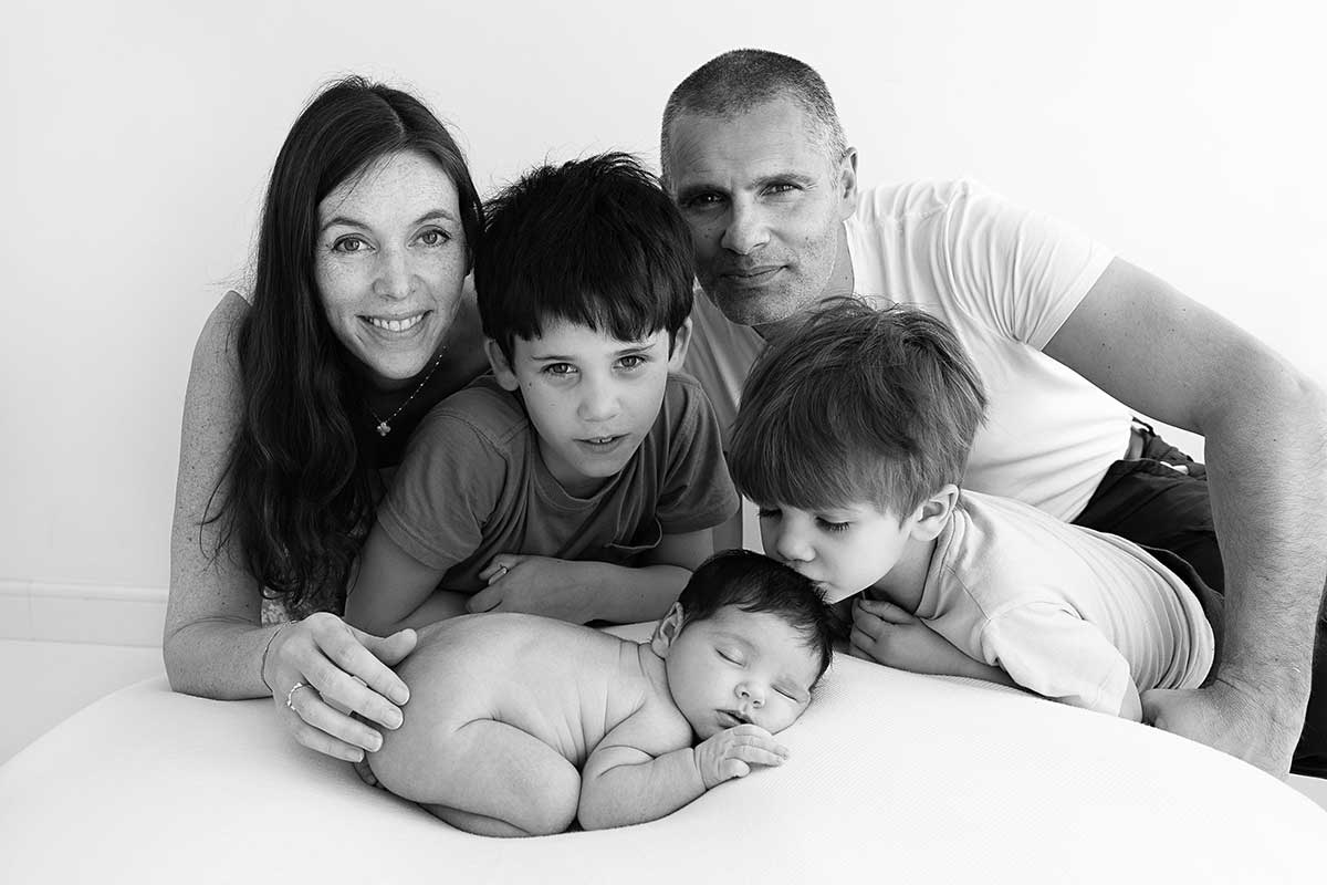 Family of five with two older siblings and a newborn baby during a London newborn photography session.