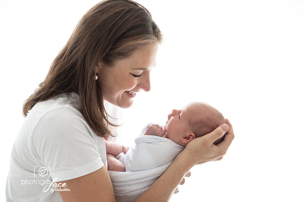 mum holding and looking at her baby