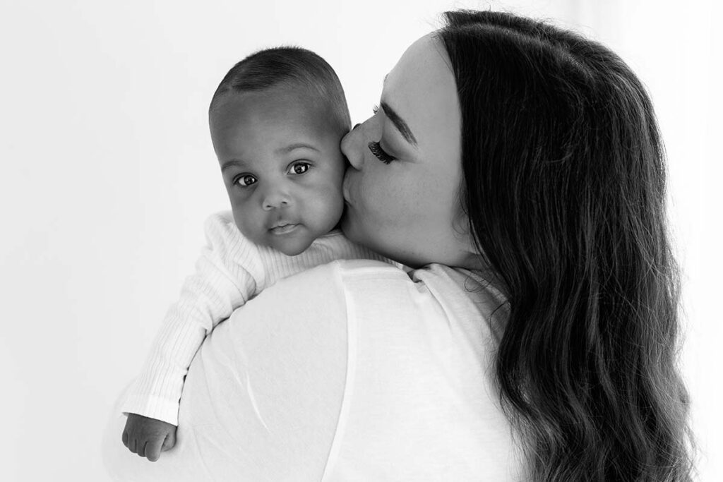 Mum kissing her baby during a photoshoot in London