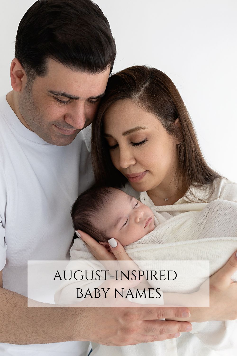 Parents holding new baby during a studio photoshoot by Photography by Valentina.