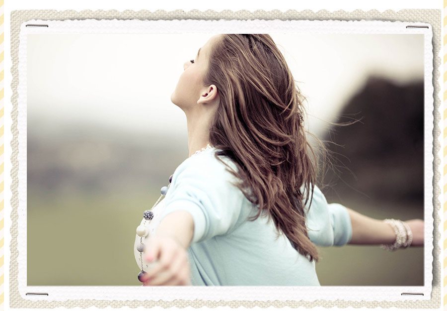woman with open arms breathing the air