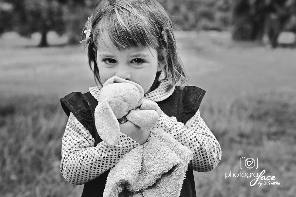 girl hugging soft toy during an outdoor shoot. Photo taken in Clapham 