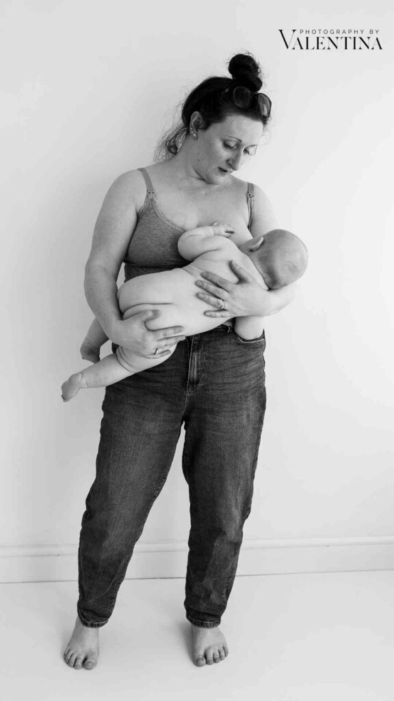 black and white photo of mum holding and feeding her 7 month old baby. 