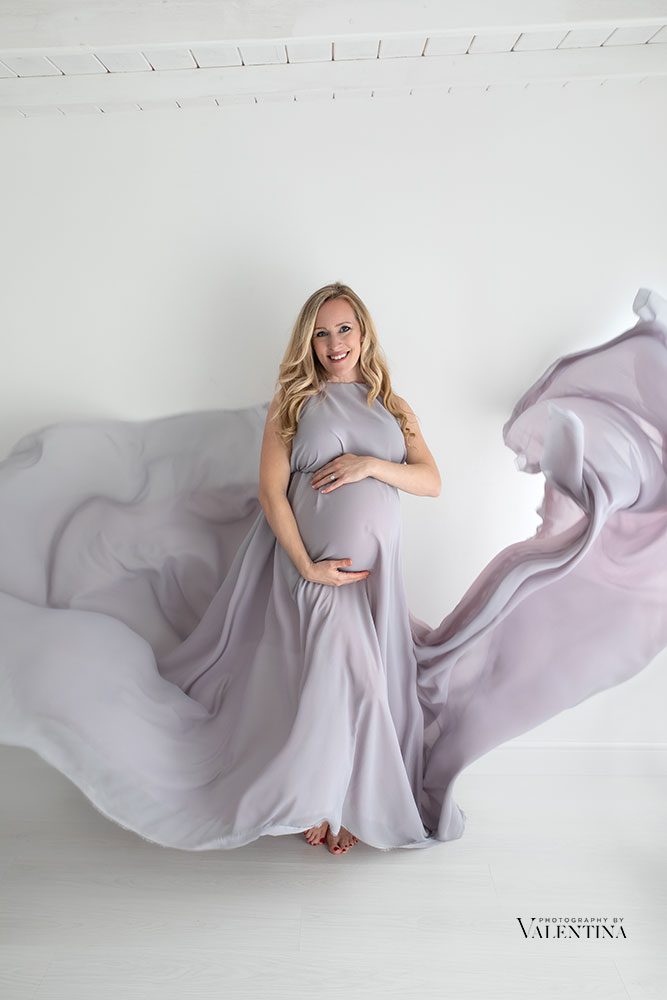 Artistic maternity photos using flowing fabric and chiffon in neutral tones