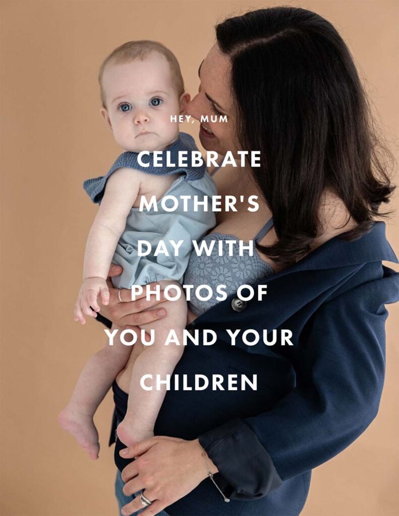 Mum holding baby girl and smiling.