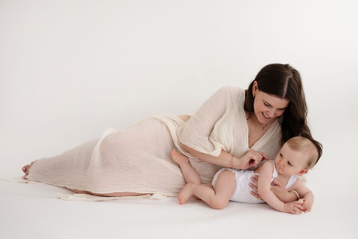 Mum laying on the floor with her baby during a mummy and me session in London with Valentina
