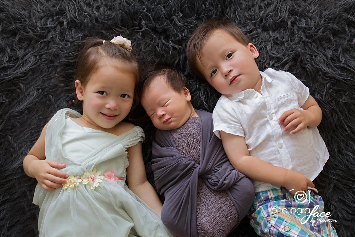 portrait of siblings laying on the floor