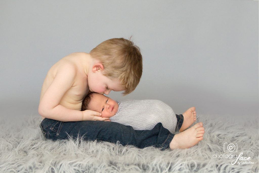 newborn photographer London - sibling kiss