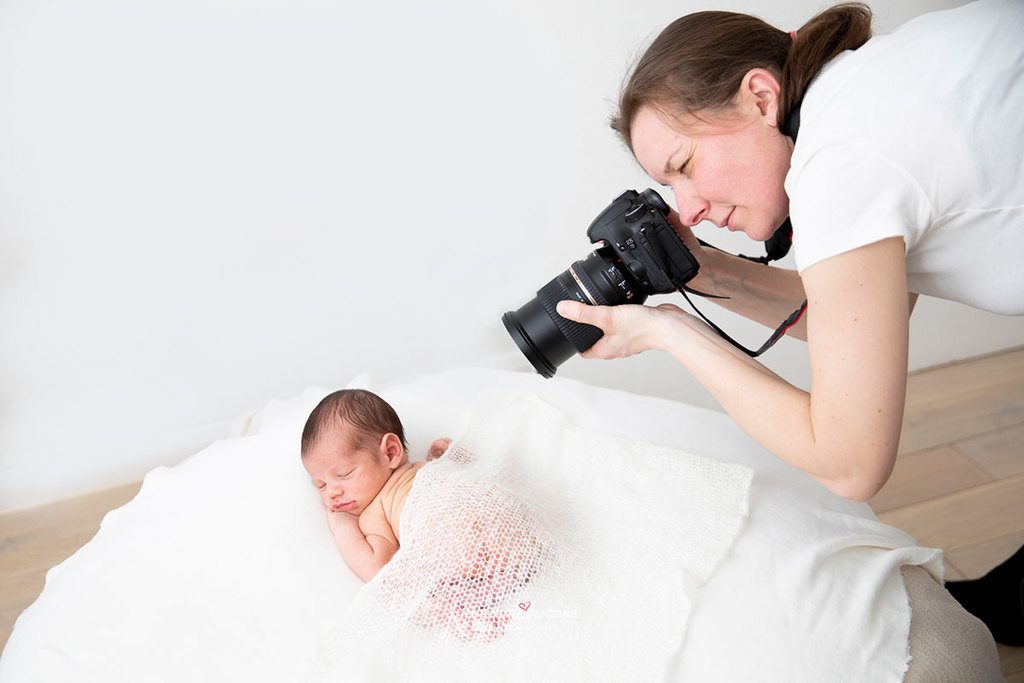 behind the scene: london newborn photographer valentina taking photo of a baby newborn