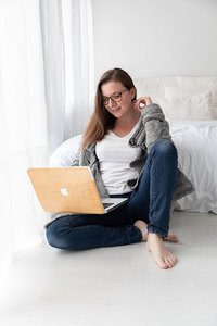 newborn photographer in Richmond Valentina, sitting in front of the computer in her studio.