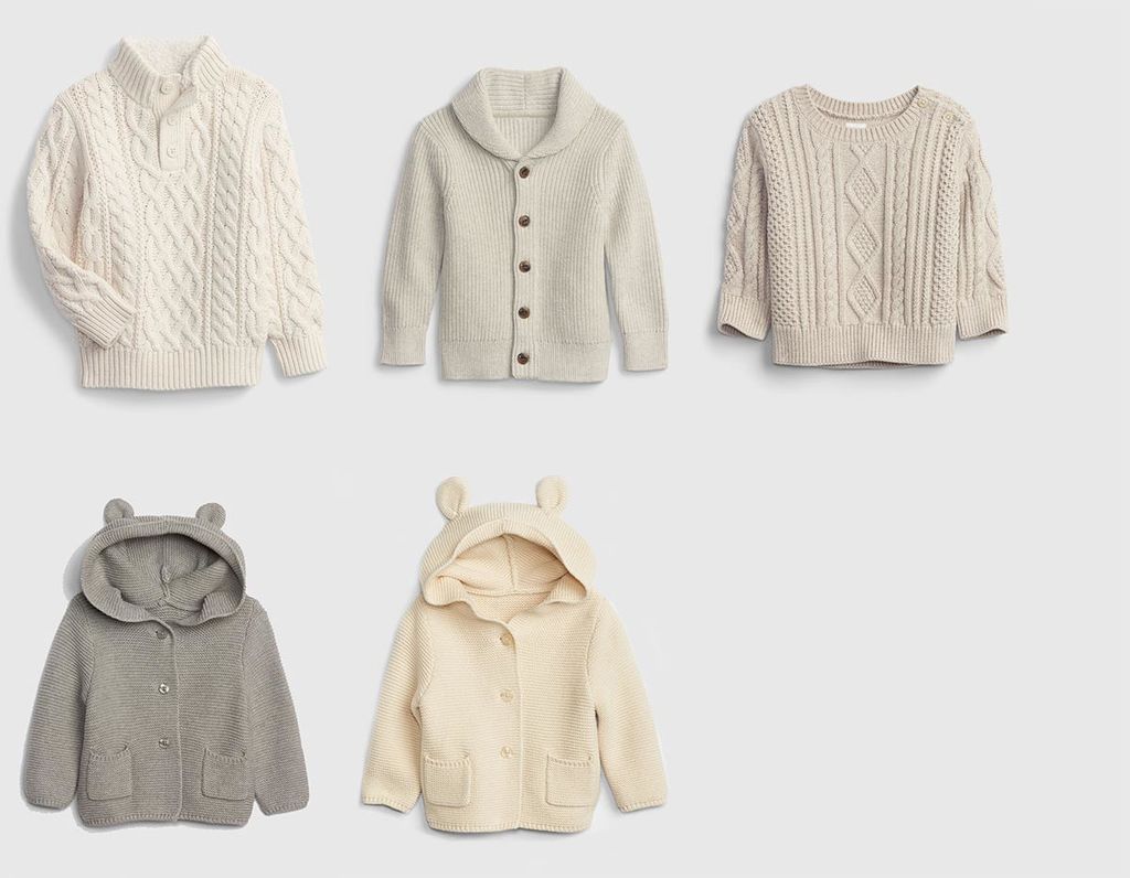 Flat lay of four winter girl outfits including cable-knit jumpers with a palette of beige, grey, and ivory